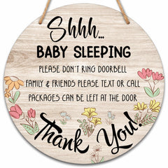Valucise baby sleeping sign on front door showing rustic round wood decor.