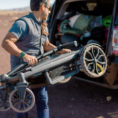 Veer All-Terrain Cruiser folded for compact storage in a sedan trunk