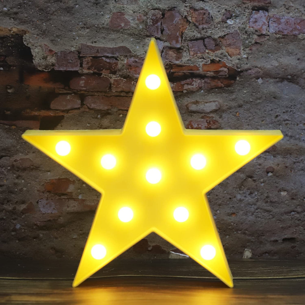 Vicila LED marquee star light glows softly to brighten a child's nursery.