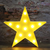 Vicila LED marquee star light glows softly to brighten a child's nursery.
