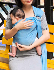 Vlokup baby in high chest position demonstrates kissable contact during water use.