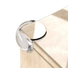 Vobulafy clear corner protectors installed on a table edge for kid safety.