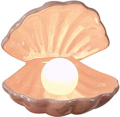 Vosarea shell pearl night light pink on bedside table with soft glow