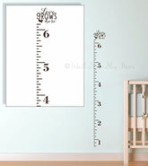 Wall Decor Plus More growth chart in chocolate brown with height marks for years.