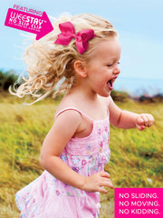 Light pink Wee Ones bow worn in hair for versatile daily style.