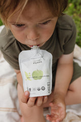 BPA-free pouch in use for on-the-go feeding with a toddler.