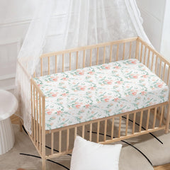 Winpema pink floral crib sheet showing secure fit on standard crib.