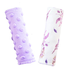 Wirein purple floral carseat strap cover on baby's shoulder reduces chafing during travel