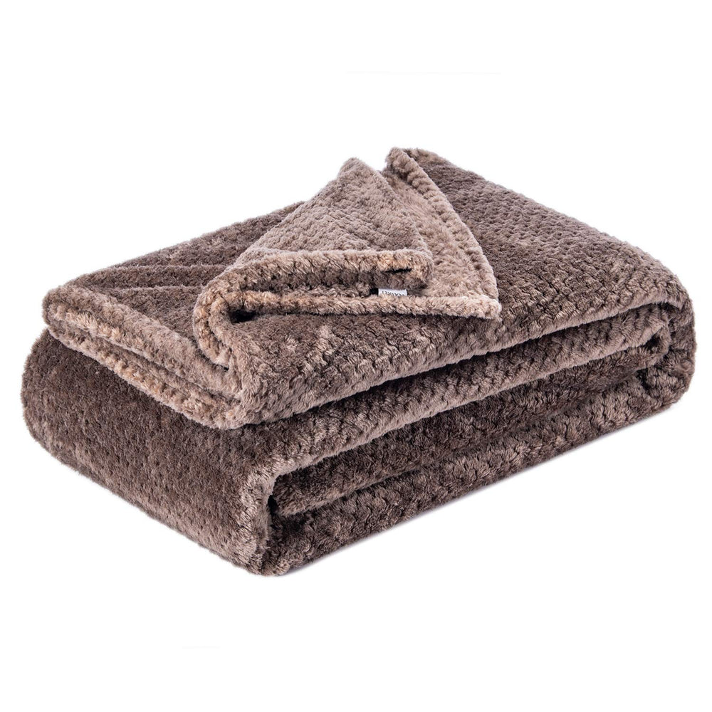 Wonder Miracle fuzzy throw blanket laid on a bed for cozy warmth.