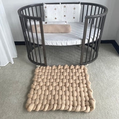 Wonder Space knotted braided plush mat, side view, soft tummy time surface.