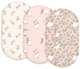 Woodiville Bassinet Sheets Blush Bunny two-pack on clean bed for newborn comfort