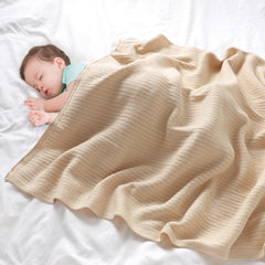 Wugugu cotton knit blanket closeup shows breathable, soft fabric.