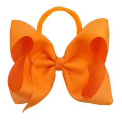 Xansema ribbon bow headband showcases a bold orange accent for photos.