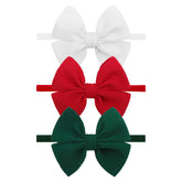 YanJie 4'' Christmas bows headband on newborn, soft and secure.
