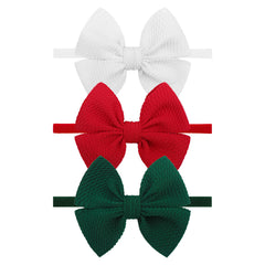 YanJie 4'' Christmas bows headband on newborn, soft and secure.