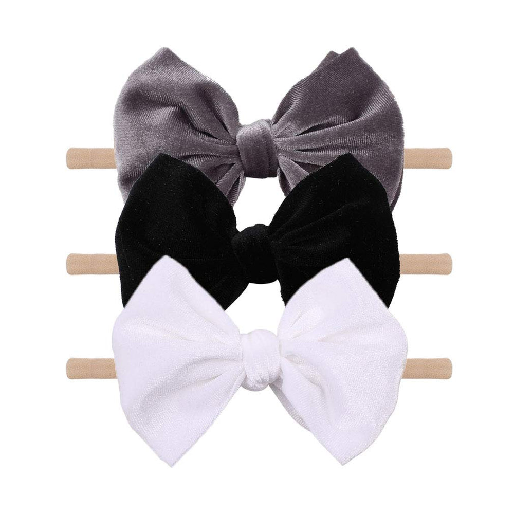 YanJie velvet bow on a black headband showing soft texture and gentle padding for newborns