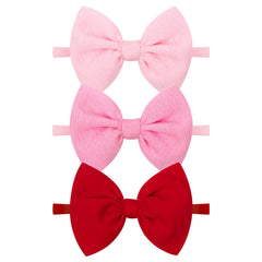 YanJie baby bows on a red pink headband, gentle comfort for newborns.
