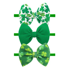 YanJie St. Patrick's Day headband with green bows for adorable newborn photos.