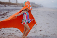 Yikes Twins hooded dino towel hood close-up emphasizes eyes and horns.
