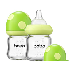 YOHKOH natural glass baby bottle in green shows clear measurements support accurate feeding.