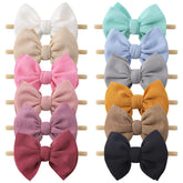 Yoyokid 12-piece bow headbands on a soft nylon band for gentle daily wear.