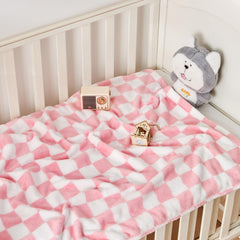 Yurhap pink checkered baby blanket laid flat on crib for cozy naps.