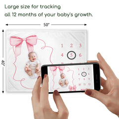 Yuzioey pink bow milestone blanket used as photoshoot backdrop for growth milestones