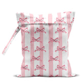 zcyxuuw wet bag front view in pink bow stripes, ideal for beach gear.