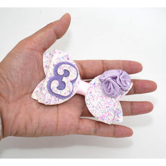 Zlwse birthday bow with alligator clip keeps hairstyle in place.