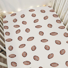 ZoUbqchY cream watercolor footballs crib sheet fits standard cribs for secure sleep.