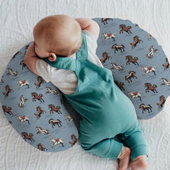 ZoUbqchY blue nursing cover on a pillow, showcasing cozy breathable fabric for baby feeding.