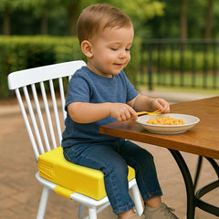 AAAini booster seat non-slip bottom in yellow helps stay put during meals.