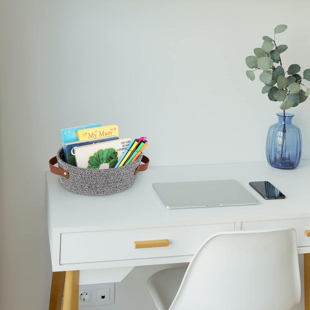 ABenkle shelf basket with oval shape complements decor while organizing remotes.