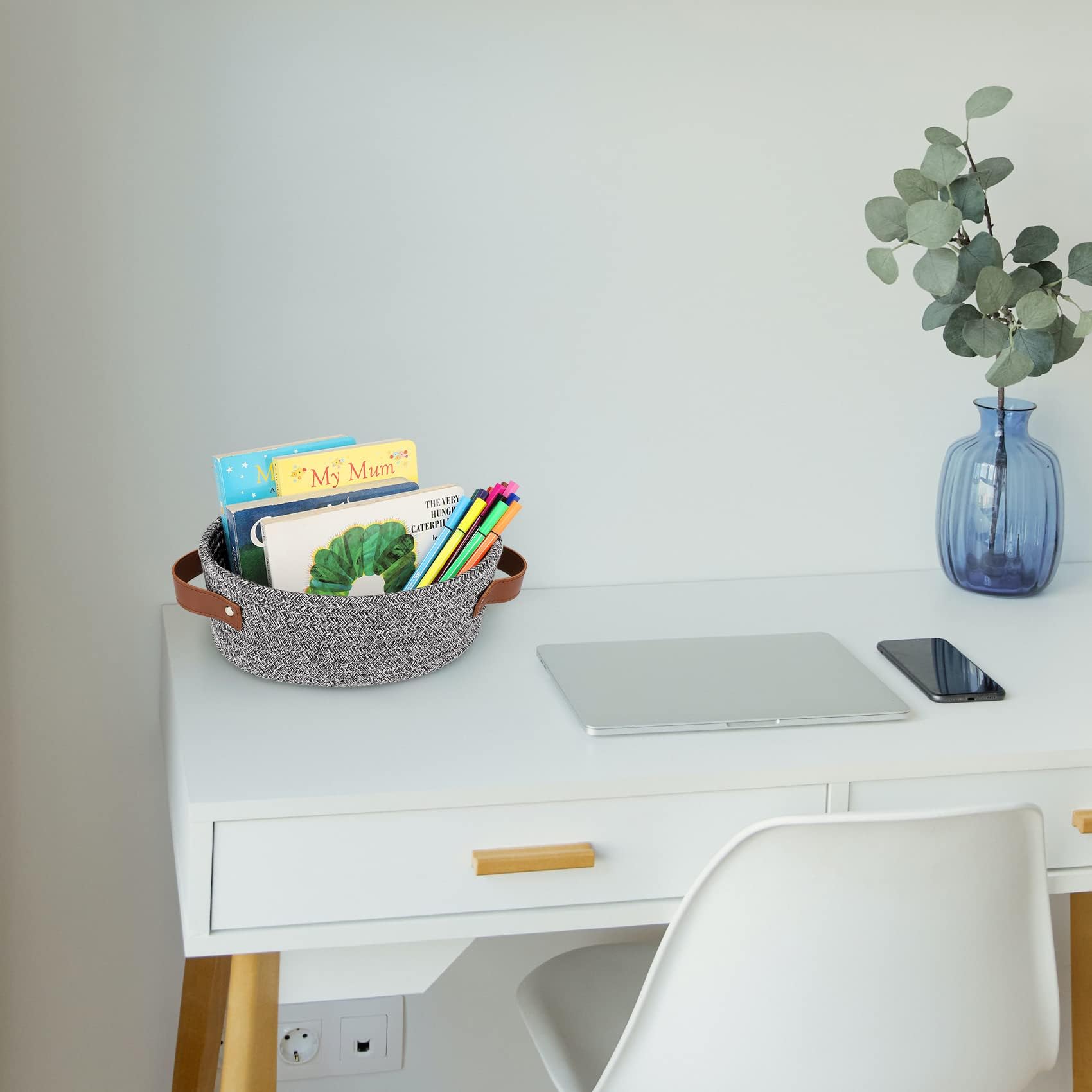 ABenkle white-handled basket complements any room decor.