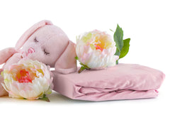 Abstract baby sheets close-up shows ultra-soft cotton texture ideal for skin and easy care.