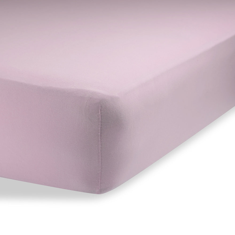 Abstract bassinet sheets in solid pink offer breathable, gentle comfort for baby sleep.