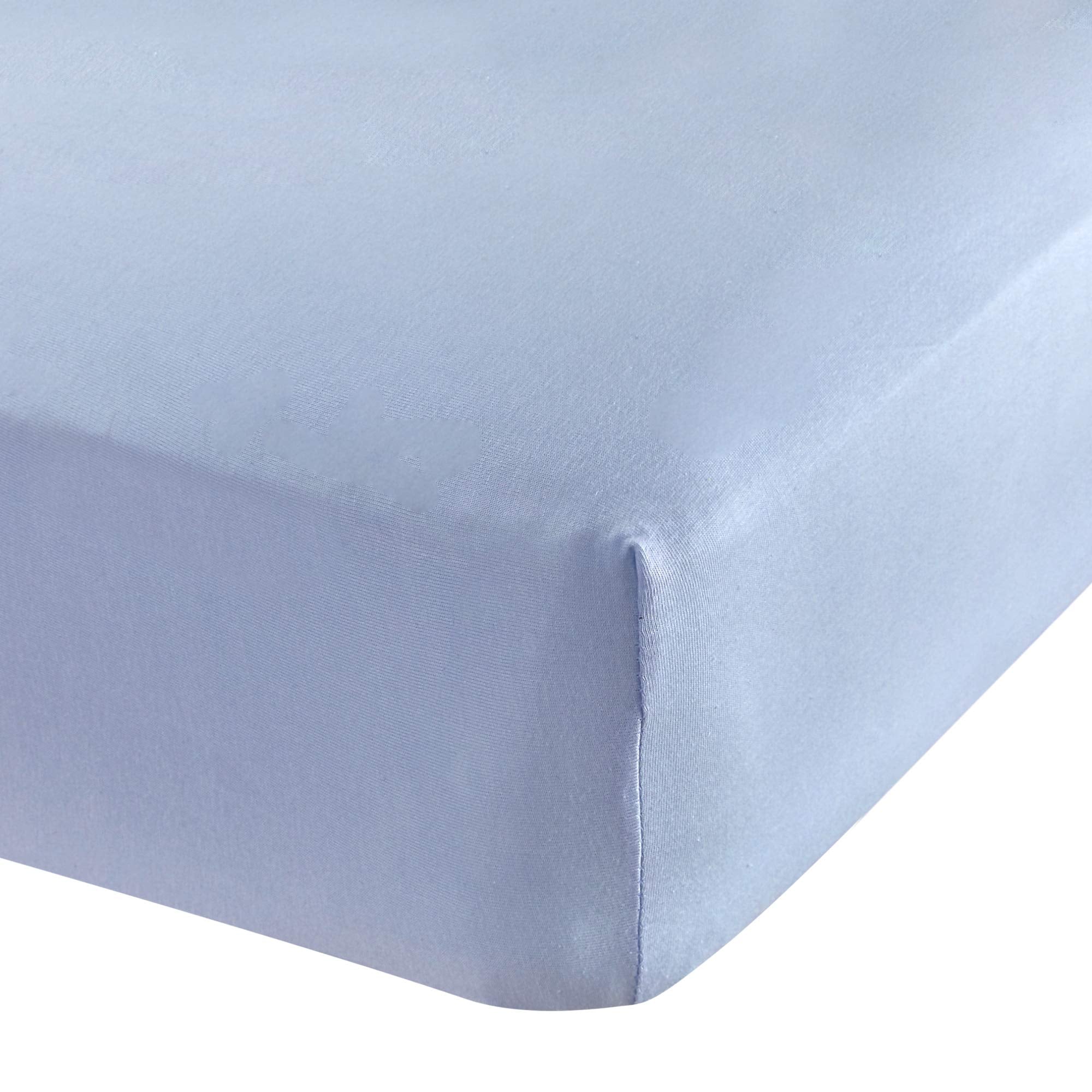 Abstract Cotton Crib Sheet in solid blue fitted neatly on a standard crib mattress.