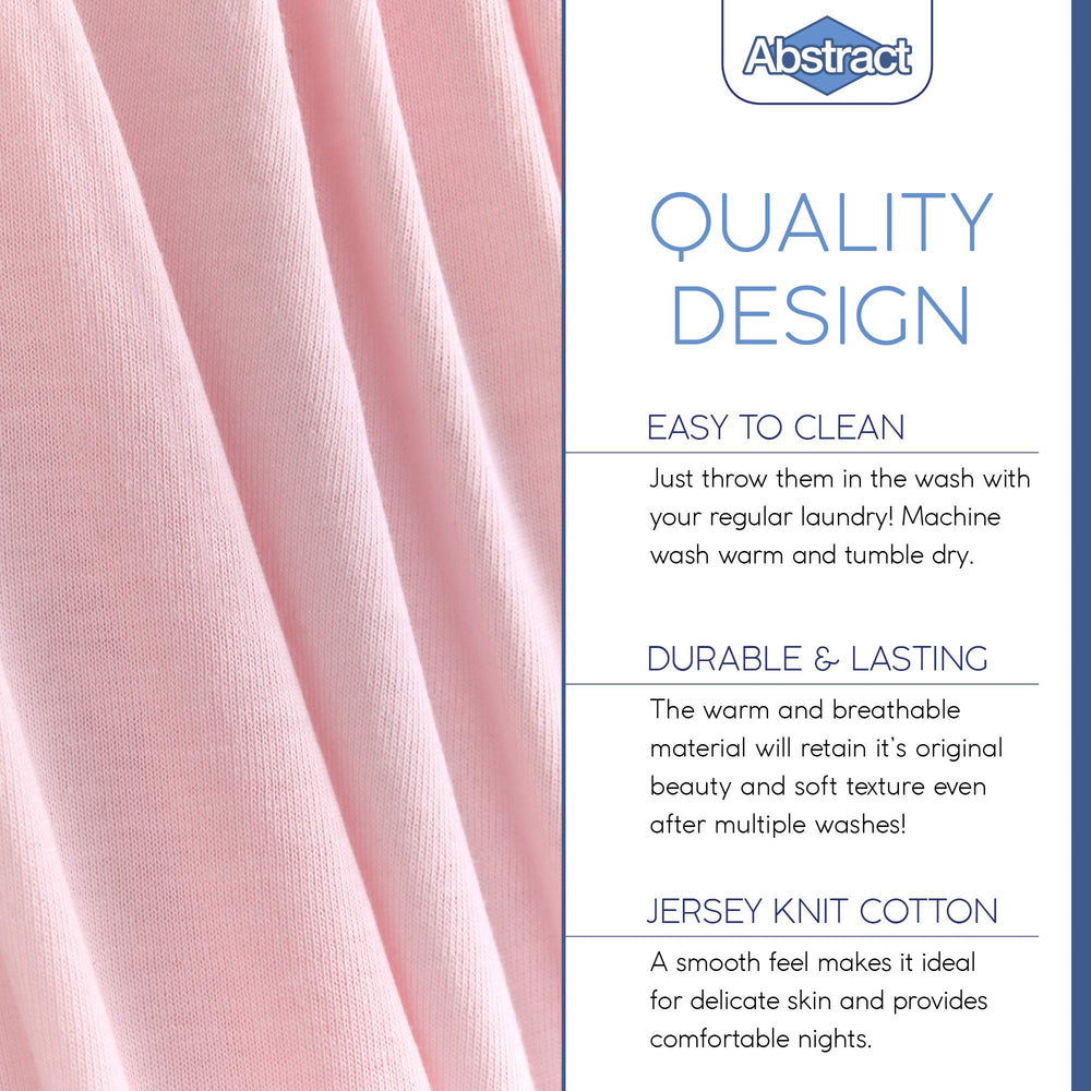 Stacked pink Abstract crib sheets illustrate color and fabric quality.