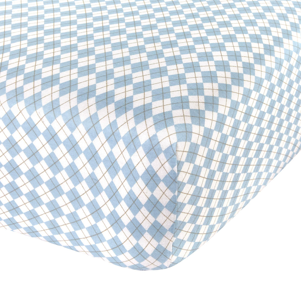 Abstract cotton crib sheets with blue argyle pattern for cozy nights.