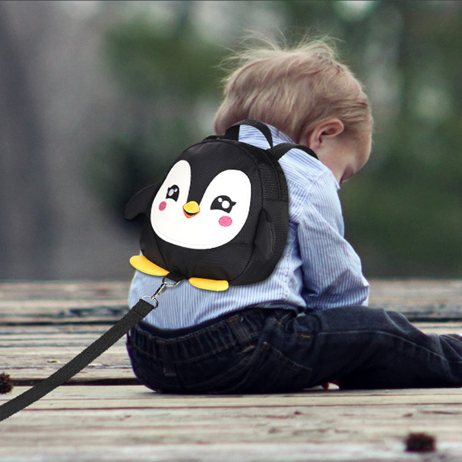 Accmor penguin backpack shows diaper and wipes storage in a tiny travel pack.