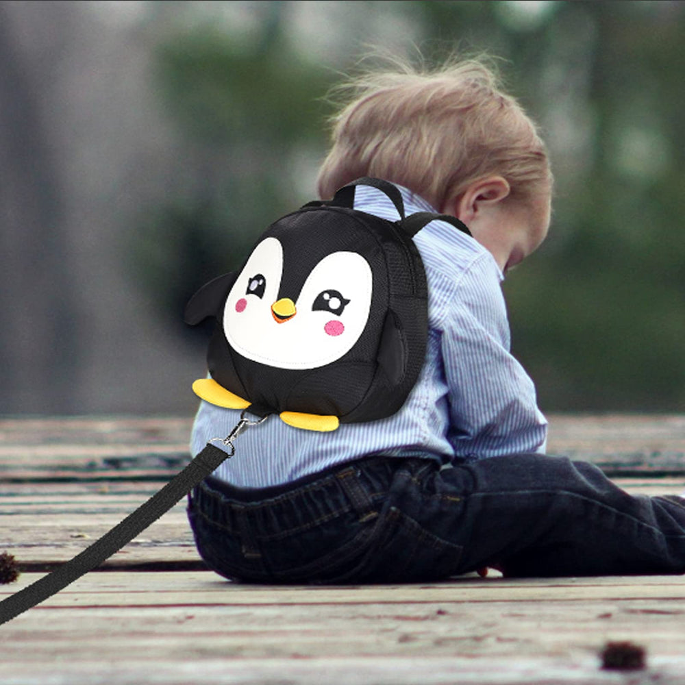 Accmor penguin backpack shows diaper and wipes storage in a tiny travel pack.