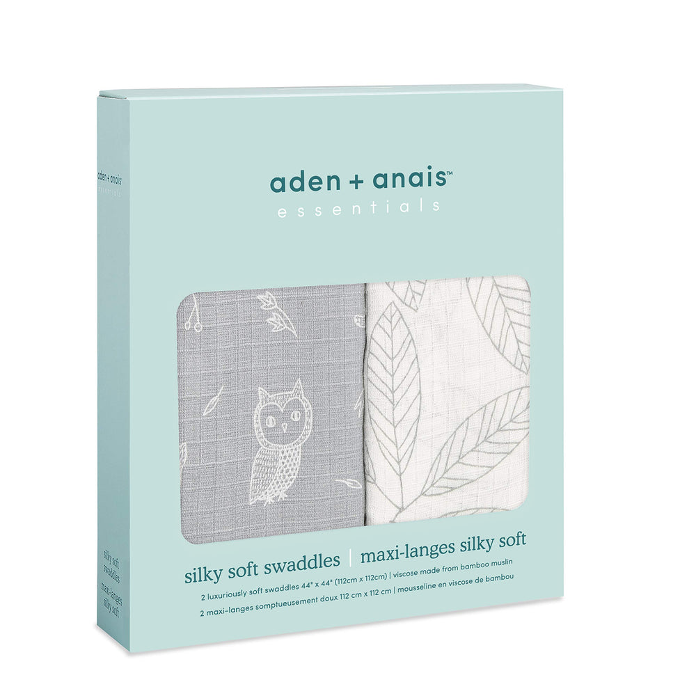 aden + anais silky soft swaddle wrapped around baby for secure, gentle swaddling