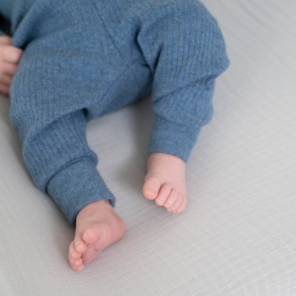 aden and anais changing pad cover with slots for restraint straps shown.