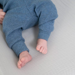 aden and anais changing pad cover with slots for restraint straps shown.