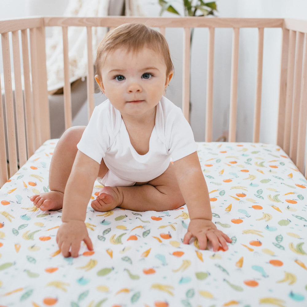aden + anais Essentials crib sheet snug fit demonstrates secure, tailored protection for standard crib mattresses