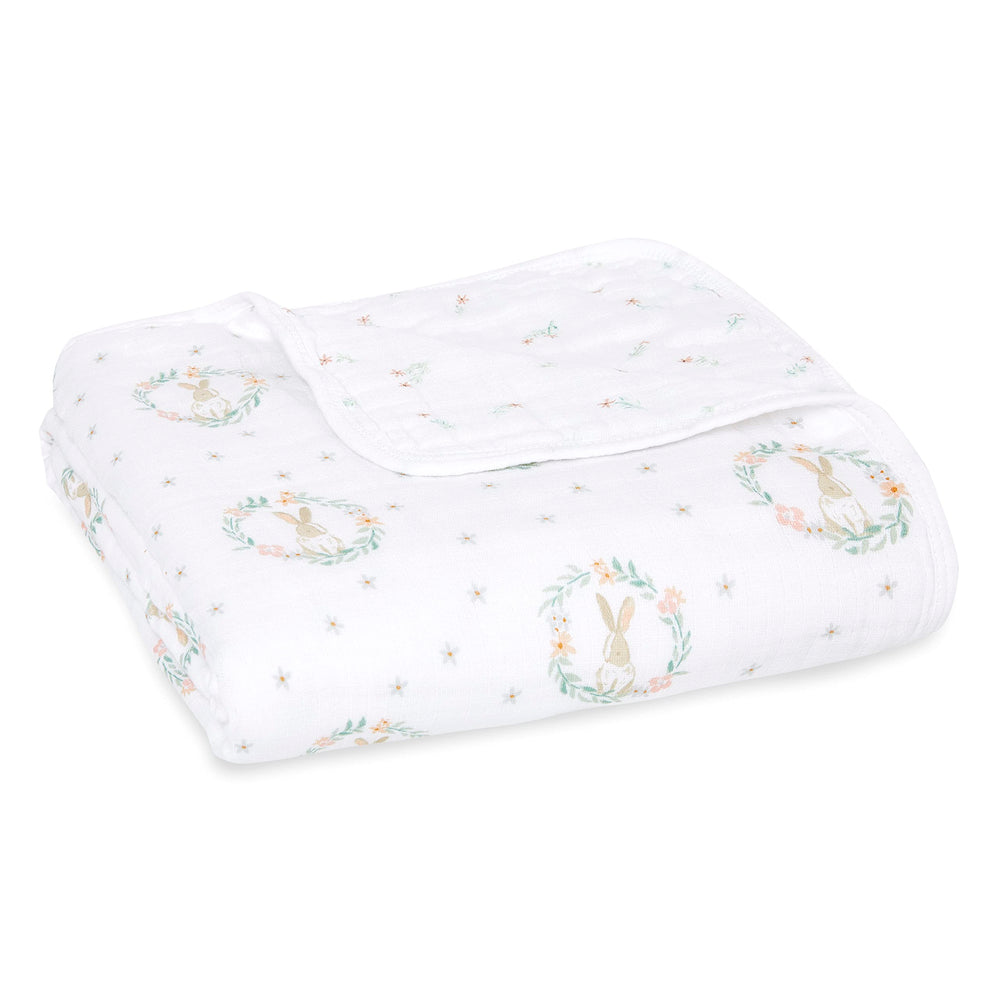 aden + anaïs Essentials Dream Blanket laid flat, breathable four-layer muslin for newborn comfort.