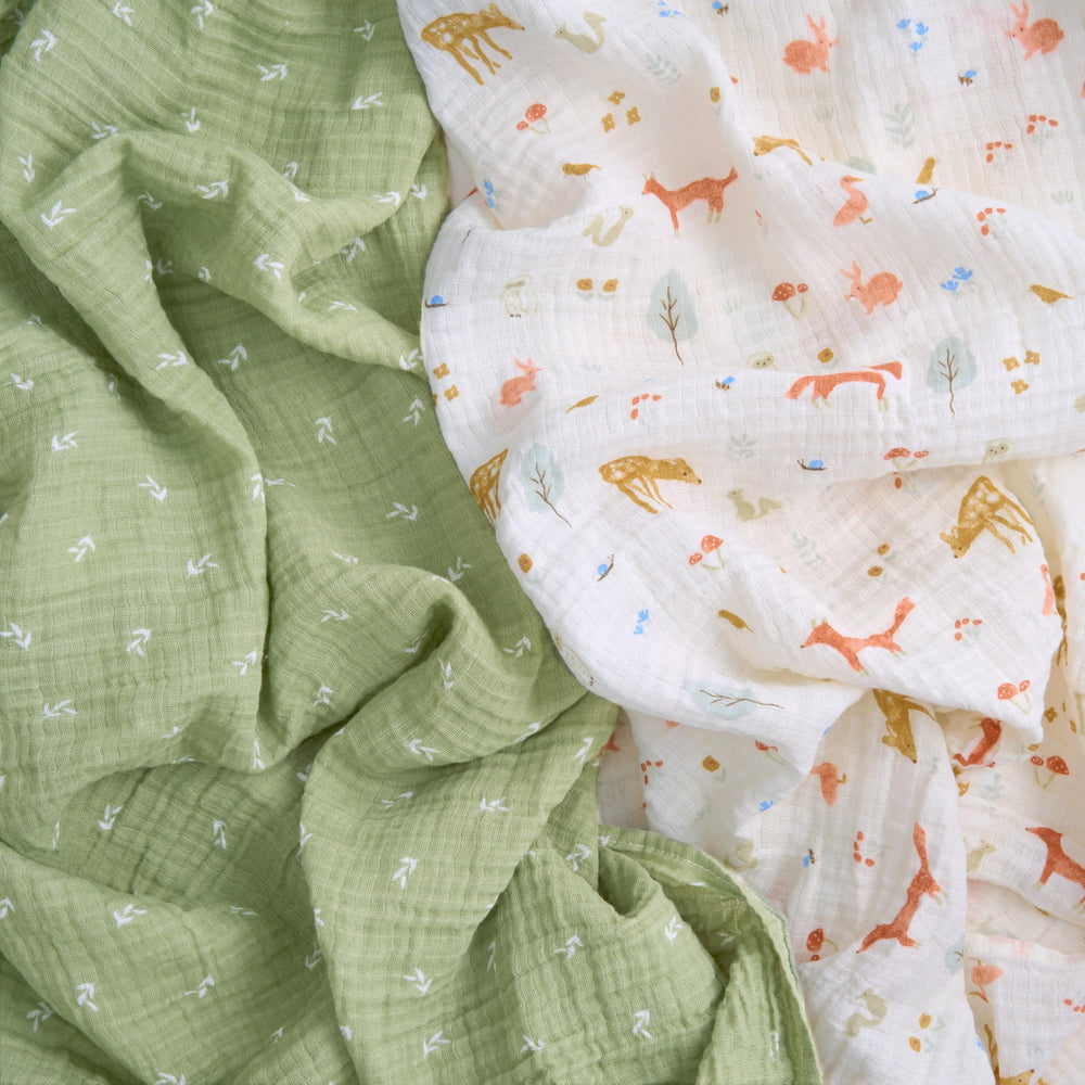 aden + anais Essentials Muslin Swaddle wrapped around newborn for gentle breathable swaddling
