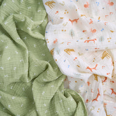 aden + anais Essentials Muslin Swaddle wrapped around newborn for gentle breathable swaddling