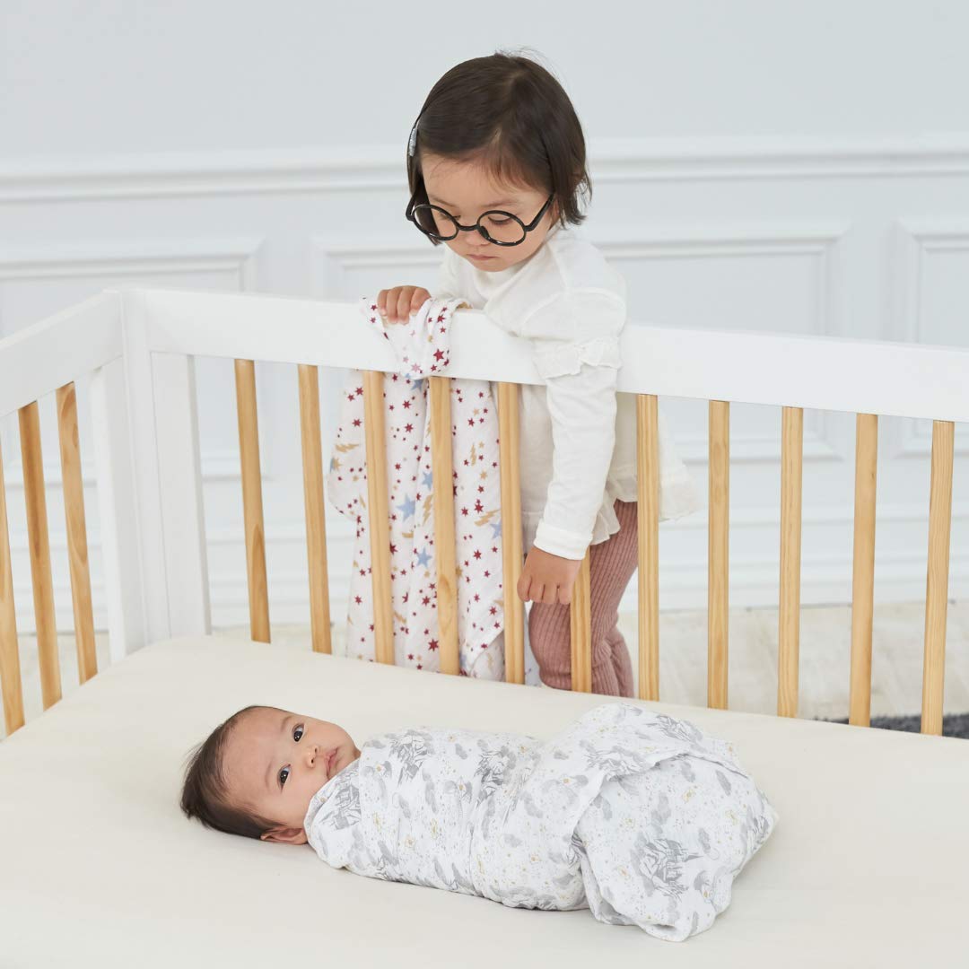aden + anais Harry Potter swaddle blanket swaddling position demonstrates snug wrap for sleep