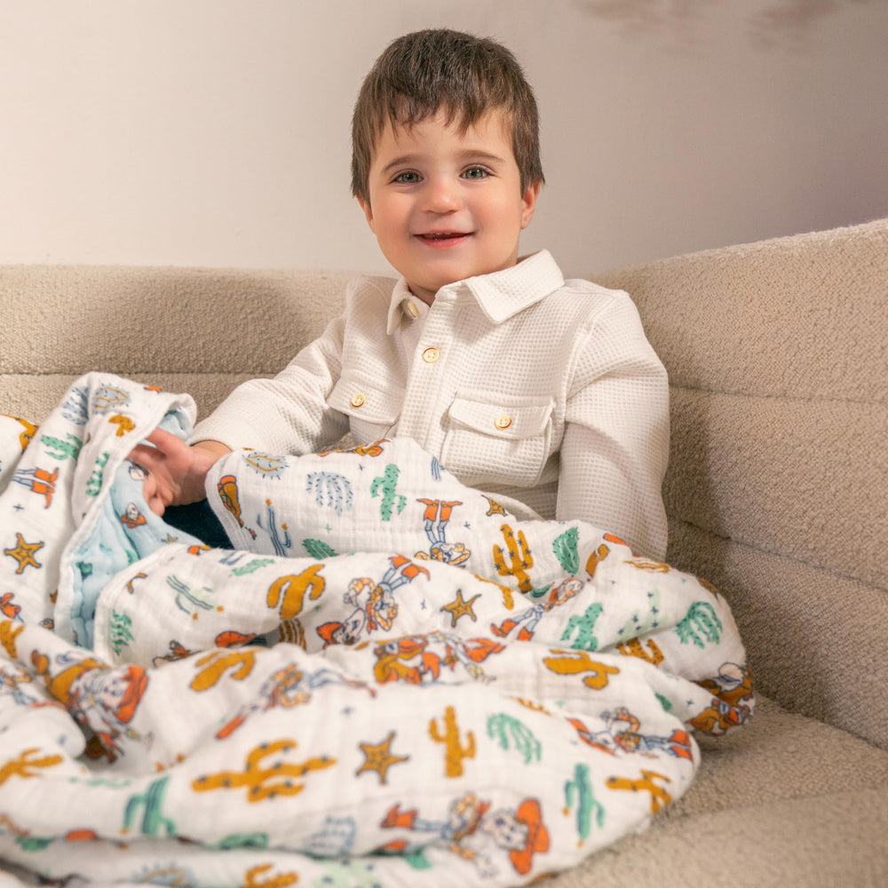 aden-anais Woody and Friends blanket tummy time proves breathable fabric for play.